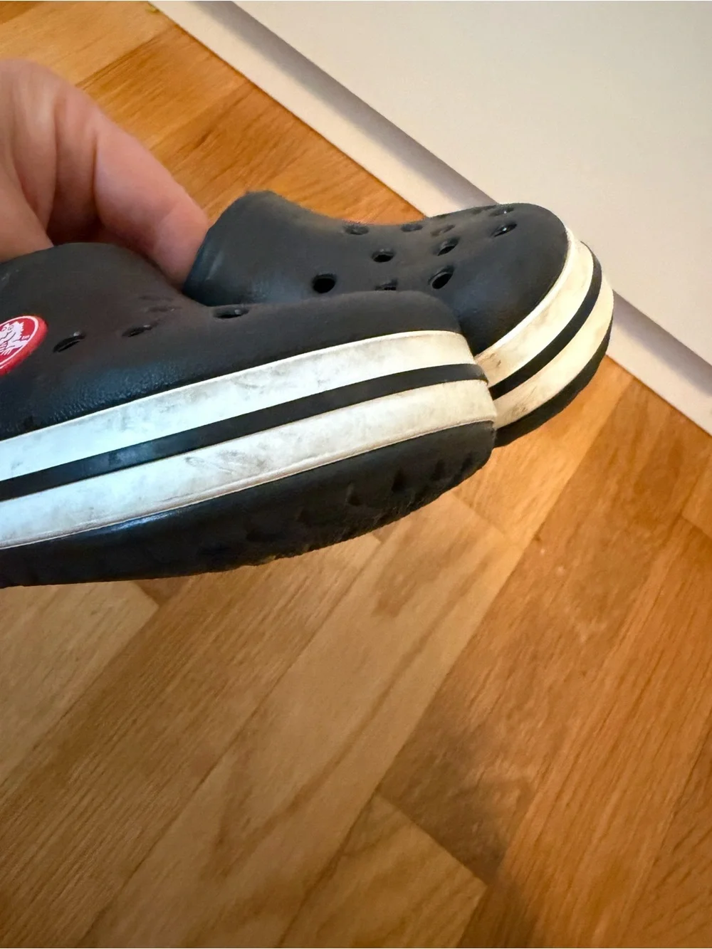 Kid’s black Croc slip on shoe with white band size 8